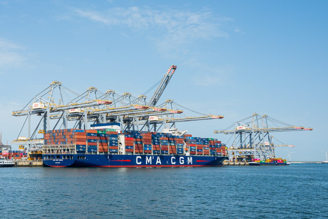 A large container ship docked at a busy port